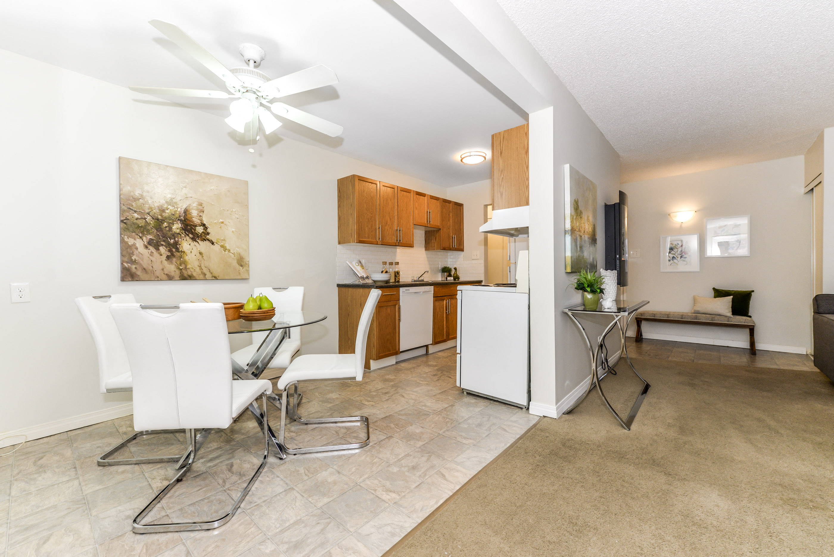 a living room with a dining room table and chairs and a kitchen